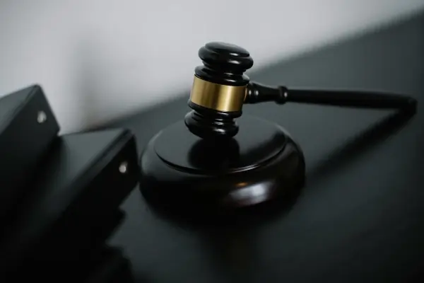 A gavel and legal binders on a table